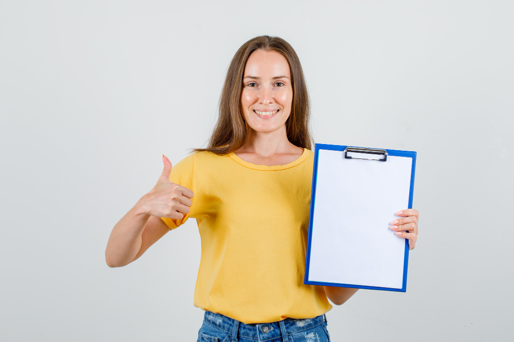 woman with thumbs up while holding blank chart