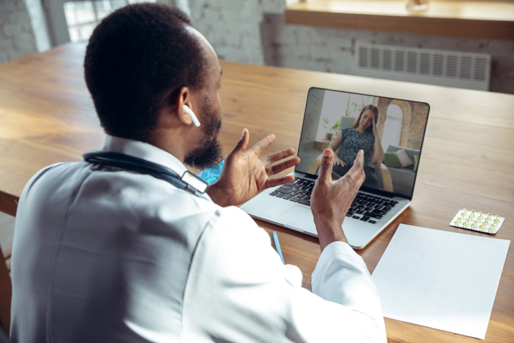 woman having tele-health primary care online consultation with her doctor