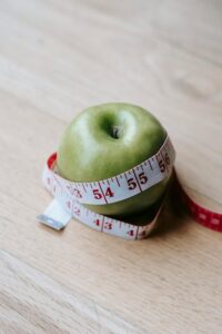 apple wrapped around measuring tape
